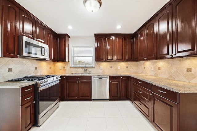 4530 T C Jester Blvd, Houston, TX 77018 - kitchen with appliances with stainless steel finishes, light stone countertops, backsplash, light tile patterned floors, and recessed lighting