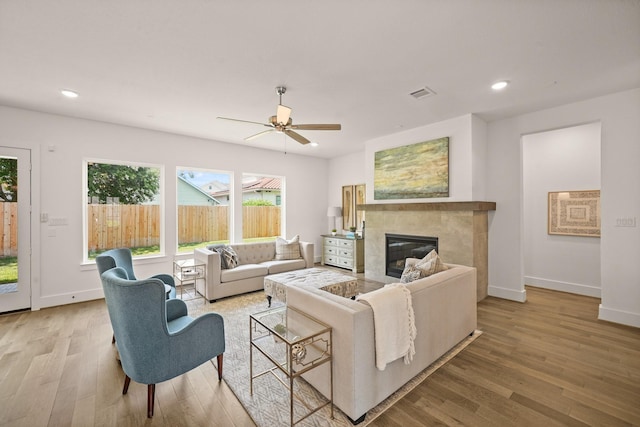 5317 Schumacher Ln, Houston, TX 77056 - living room with wood finished floors, a tiled fireplace, a ceiling fan, and recessed lighting
