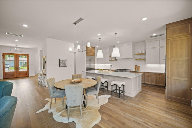 5317 Schumacher Ln, Houston, TX 77056 - dining room with french doors, recessed lighting, and light wood-type flooring
