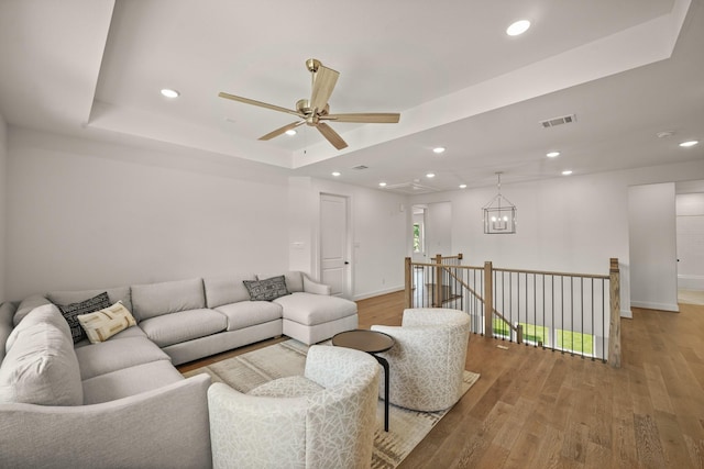 5317 Schumacher Ln, Houston, TX 77056 - living room featuring light wood-type flooring, a tray ceiling, a ceiling fan, and recessed lighting