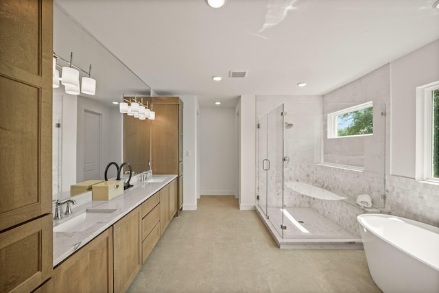 5317 Schumacher Ln, Houston, TX 77056 - bathroom with a freestanding tub, a shower stall, double vanity, recessed lighting, and tile patterned flooring