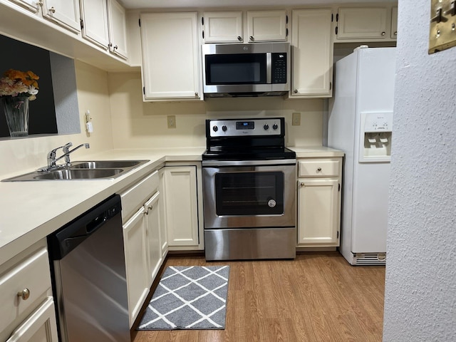 14911 Wunderlich Dr Unit 211, Houston, TX 77069 - kitchen with stainless steel appliances, light wood-style floors, light countertops, and white cabinetry