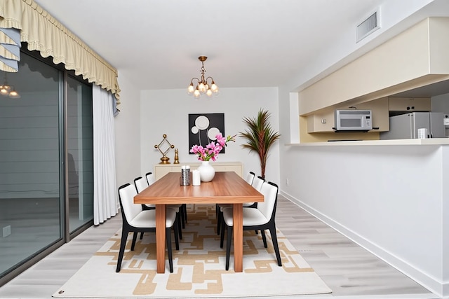 14911 Wunderlich Dr Unit 211, Houston, TX 77069 - dining space with light wood-style flooring and a chandelier