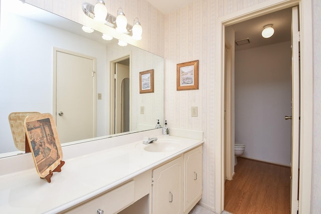 14911 Wunderlich Dr Unit 211, Houston, TX 77069 - bathroom featuring vanity, wood finished floors, and wallpapered walls