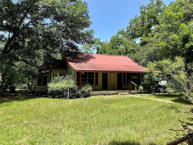 193 Corry Jones, Livingston, TX 77351 - view of front facade with a front yard, a porch, and a metal roof