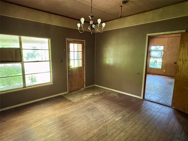 193 Corry Jones, Livingston, TX 77351 - unfurnished dining area featuring hardwood / wood-style flooring, a chandelier, healthy amount of natural light, wood ceiling, and wooden walls