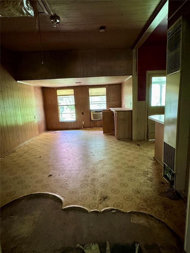 193 Corry Jones, Livingston, TX 77351 - unfurnished living room featuring wooden walls, plenty of natural light, light floors, a heating unit, and cooling unit
