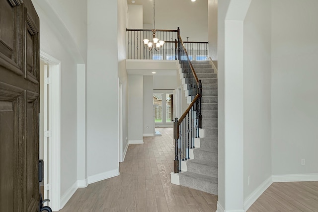 20010 Barrow Edge Ln, Cypress, TX 77433 - entrance foyer with a chandelier, light wood finished floors, stairway, and a towering ceiling