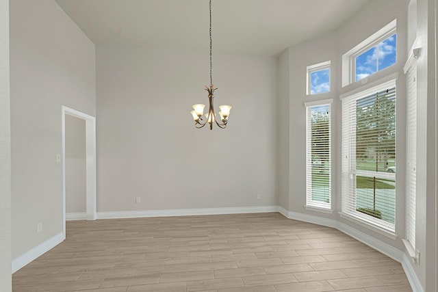 20010 Barrow Edge Ln, Cypress, TX 77433 - unfurnished room featuring a chandelier, light wood finished floors, and a towering ceiling