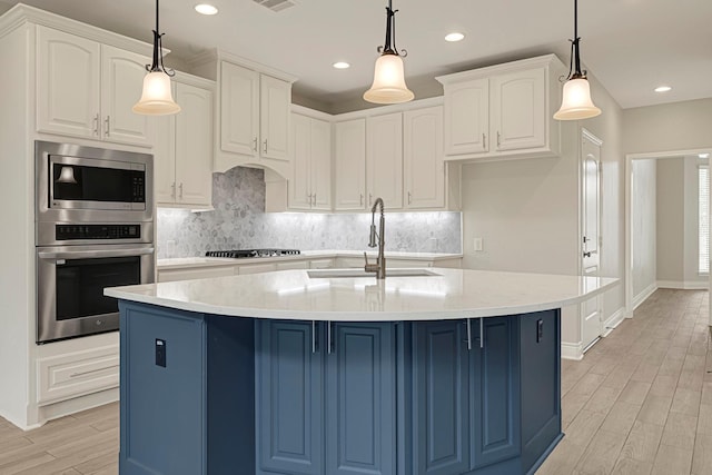 20010 Barrow Edge Ln, Cypress, TX 77433 - kitchen featuring appliances with stainless steel finishes, blue cabinets, backsplash, white cabinetry, and recessed lighting