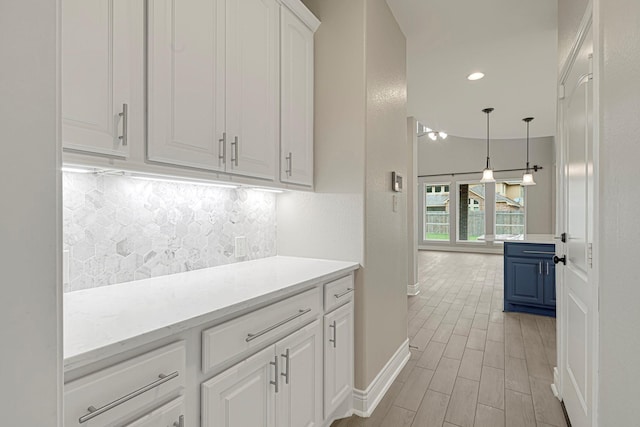 20010 Barrow Edge Ln, Cypress, TX 77433 - kitchen with light countertops, tasteful backsplash, white cabinets, hanging light fixtures, and recessed lighting