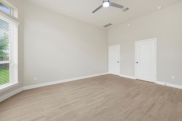 20010 Barrow Edge Ln, Cypress, TX 77433 - empty room with light wood finished floors, a ceiling fan, and a towering ceiling