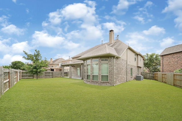 20010 Barrow Edge Ln, Cypress, TX 77433 - rear view of property with brick siding, a fenced backyard, and a chimney