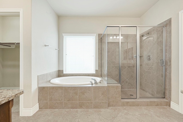 20010 Barrow Edge Ln, Cypress, TX 77433 - bathroom with a garden tub, a stall shower, tile patterned flooring, and a spacious closet