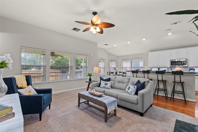 99 E Foxbriar Forest Cir, The Woodlands, TX 77382 - living area featuring plenty of natural light, light colored carpet, vaulted ceiling, ceiling fan, and recessed lighting