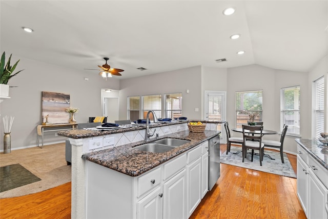 99 E Foxbriar Forest Cir, The Woodlands, TX 77382 - kitchen featuring an island with sink, dishwasher, plenty of natural light, ceiling fan, and vaulted ceiling