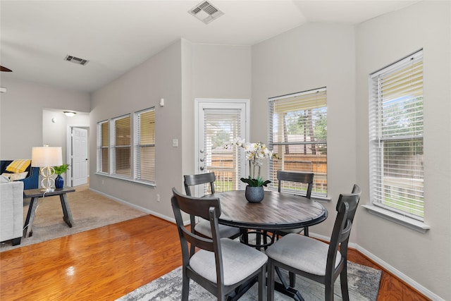99 E Foxbriar Forest Cir, The Woodlands, TX 77382 - dining space with vaulted ceiling and light wood-type flooring