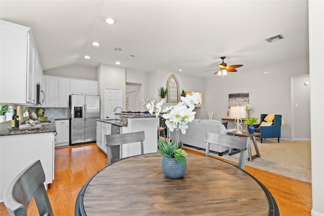 99 E Foxbriar Forest Cir, The Woodlands, TX 77382 - dining room with ceiling fan, vaulted ceiling, light wood-style floors, and recessed lighting