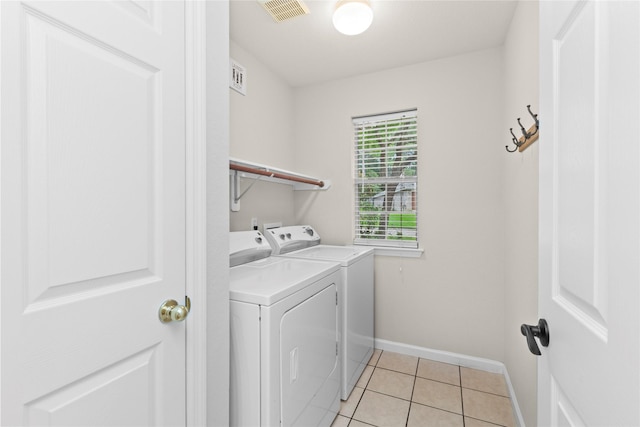 99 E Foxbriar Forest Cir, The Woodlands, TX 77382 - washroom featuring washer and clothes dryer and light tile patterned floors