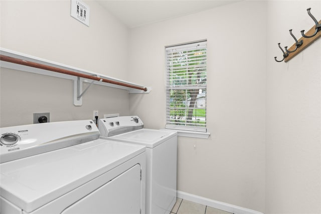 99 E Foxbriar Forest Cir, The Woodlands, TX 77382 - laundry area featuring washing machine and dryer and light tile patterned floors