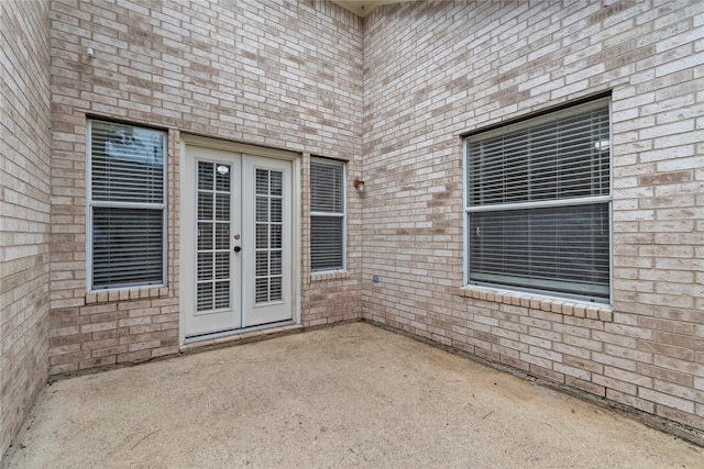 99 E Foxbriar Forest Cir, The Woodlands, TX 77382 - view of exterior entry with a patio area, french doors, and brick siding