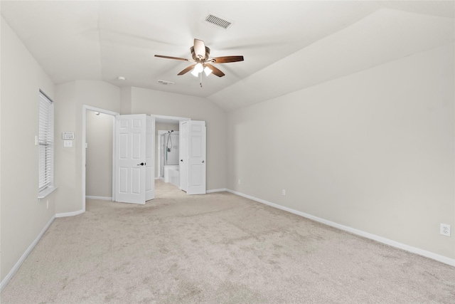 99 E Foxbriar Forest Cir, The Woodlands, TX 77382 - unfurnished bedroom with light carpet, lofted ceiling, ensuite bathroom, and a ceiling fan