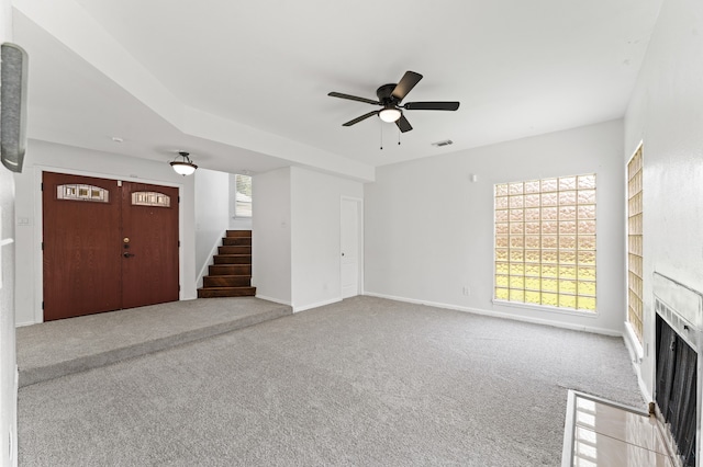 16323 Tiburon Way, Houston, TX 77053 - unfurnished living room with stairs, carpet, a fireplace with flush hearth, and ceiling fan