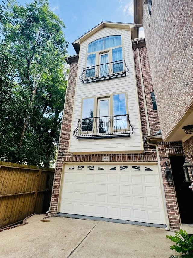 1812 Prospect St, Houston, TX 77004 - view of front of house with a garage, driveway, a balcony, and brick siding