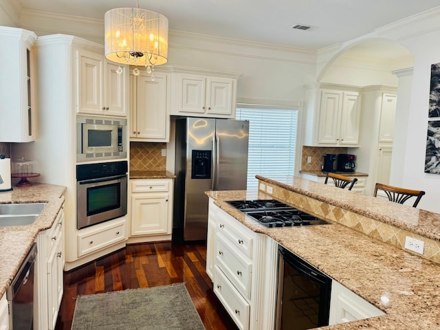 1812 Prospect St, Houston, TX 77004 - kitchen featuring appliances with stainless steel finishes, beverage cooler, dark wood-style floors, light stone countertops, and tasteful backsplash