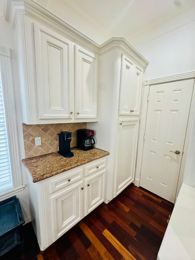 1812 Prospect St, Houston, TX 77004 - kitchen featuring dark wood-style floors, tasteful backsplash, light stone counters, and white cabinets