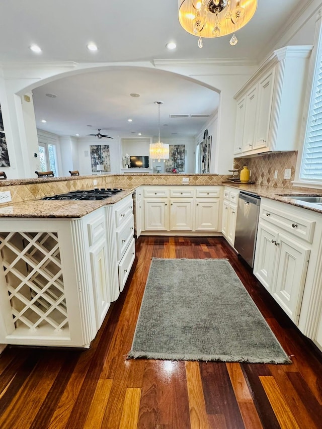 1812 Prospect St, Houston, TX 77004 - kitchen with stainless steel appliances, arched walkways, and a chandelier