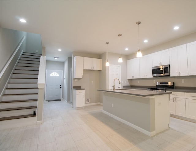 324 Gans St Unit B, Houston, TX 77029 - kitchen with appliances with stainless steel finishes, dark countertops, white cabinetry, and recessed lighting