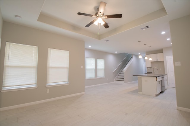324 Gans St Unit B, Houston, TX 77029 - unfurnished living room with a tray ceiling, ceiling fan, stairs, and recessed lighting