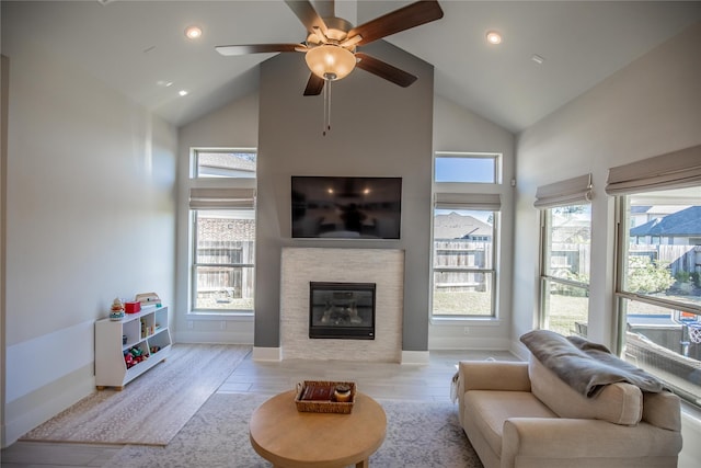 15138 Botanical Garden Dr, Conroe, TX 77302 - living area featuring high vaulted ceiling, a glass covered fireplace, healthy amount of natural light, ceiling fan, and recessed lighting