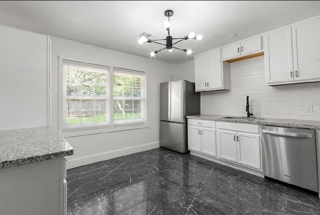 4303 Dacca Dr, Houston, TX 77047 - kitchen with stainless steel appliances, a chandelier, dark marble finish flooring, tasteful backsplash, and white cabinetry