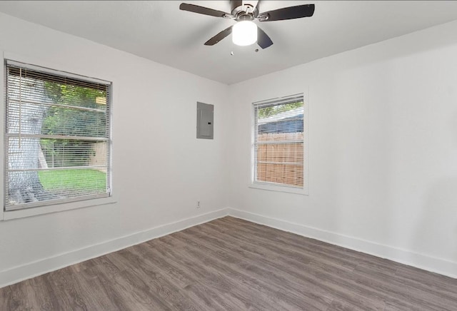 4303 Dacca Dr, Houston, TX 77047 - empty room with electric panel, wood finished floors, plenty of natural light, and a ceiling fan