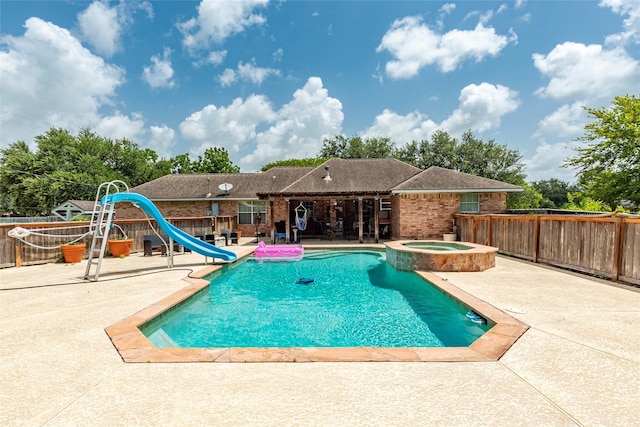 15631 Fir Rd, Santa Fe, TX 77517 - view of swimming pool with a water slide, a patio, and a pool with connected hot tub