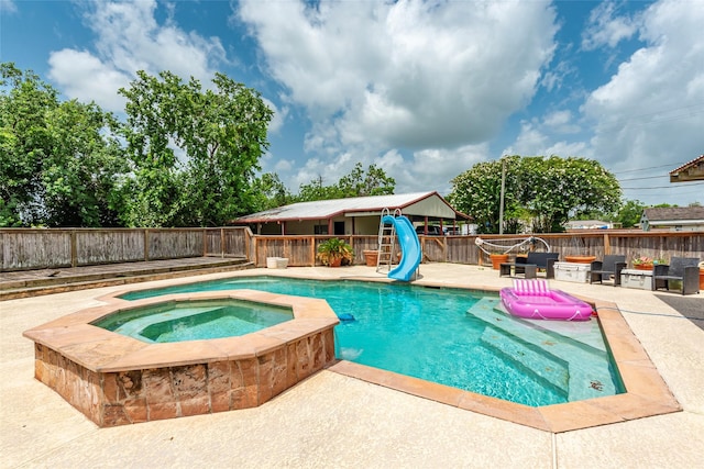 15631 Fir Rd, Santa Fe, TX 77517 - view of pool with a water slide, an in-ground hot tub, a patio area, and a fenced backyard