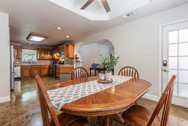 15631 Fir Rd, Santa Fe, TX 77517 - dining space featuring arched walkways, a ceiling fan, concrete flooring, recessed lighting, and a textured ceiling