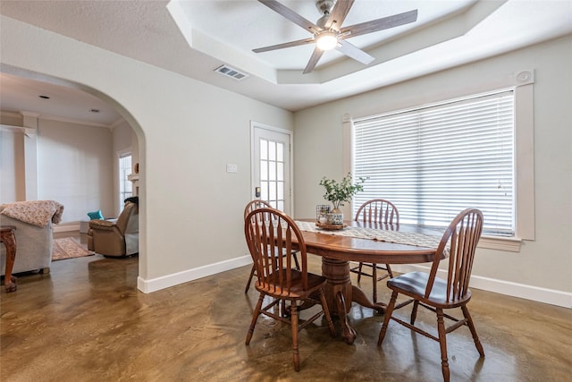 15631 Fir Rd, Santa Fe, TX 77517 - dining area featuring arched walkways, finished concrete floors, a tray ceiling, and ceiling fan