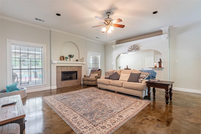 15631 Fir Rd, Santa Fe, TX 77517 - living area with concrete floors, arched walkways, a ceiling fan, ornamental molding, and a fireplace