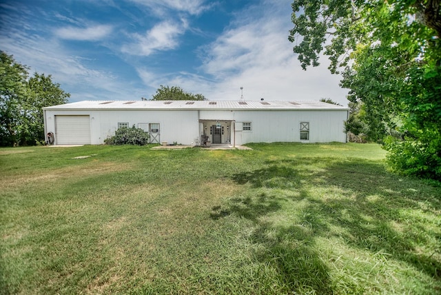 925 Royal Rd, Port Lavaca, TX 77979 - back of property featuring a yard, a garage, and a metal roof