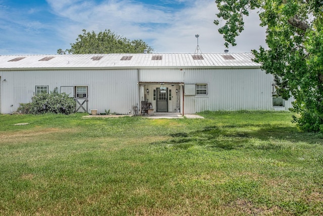 925 Royal Rd, Port Lavaca, TX 77979 - back of house with an outbuilding, a lawn, and a metal roof