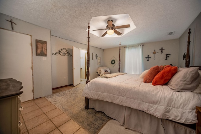 925 Royal Rd, Port Lavaca, TX 77979 - bedroom with light tile patterned flooring, ceiling fan, and a textured ceiling