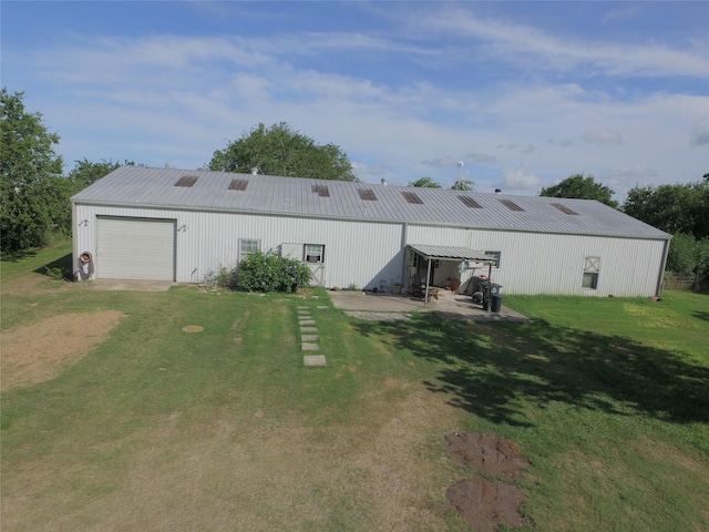 925 Royal Rd, Port Lavaca, TX 77979 - back of property featuring an outbuilding, an outdoor structure, a yard, and a metal roof