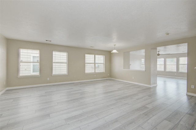 7255 Liberty Mesa Ln, Houston, TX 77049 - unfurnished room with light wood-style floors, healthy amount of natural light, and ceiling fan