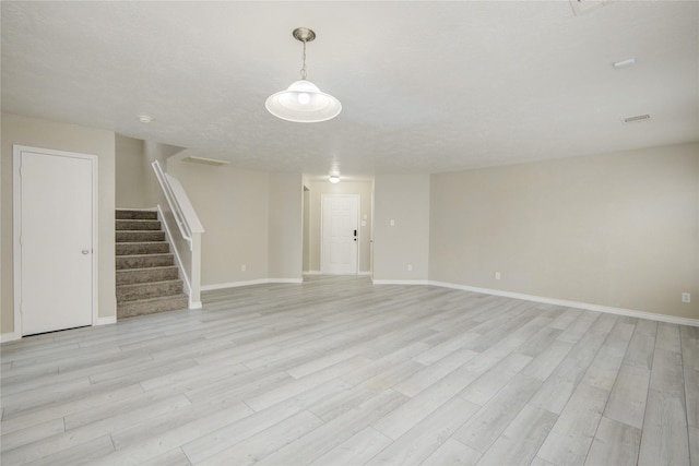 7255 Liberty Mesa Ln, Houston, TX 77049 - unfurnished living room featuring stairs and light wood-style flooring
