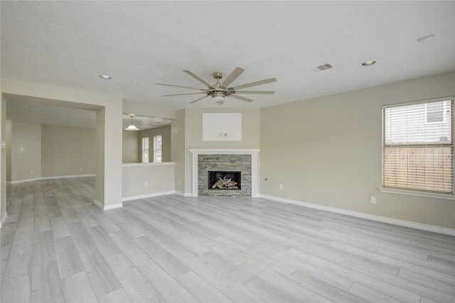 7255 Liberty Mesa Ln, Houston, TX 77049 - unfurnished living room featuring ceiling fan, light wood-style flooring, recessed lighting, and a fireplace