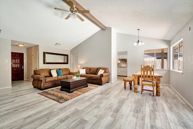 15707 Spring Forest Dr, Houston, TX 77059 - living room with wood finished floors, a textured ceiling, a chandelier, and ceiling fan
