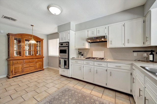 15707 Spring Forest Dr, Houston, TX 77059 - kitchen with appliances with stainless steel finishes, under cabinet range hood, light countertops, and white cabinetry